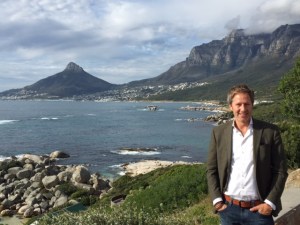 Jay Lauf In Cape Town with The Lion's Head mountaintop to his right and Table mountain to his left.